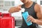 Young athletic man preparing protein shake in kitchen