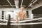 Young athletic man resting after hard training to box, fighting on the boxing ring at the gym