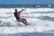 Young athletic man riding kite surf on a sea