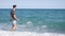 Young athletic man walking at the beach