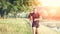 Young athletic people jogging outdoor near pond