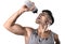 Young athletic sport man thirsty drinking water holding bottle pouring fluid on sweaty face