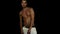 Young athletic tanned guy with naked torso starts dancing in front of camera