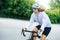 Young athletic woman cycling on a professional bike in a white helmet