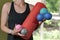 Young athletic woman holds equipment for MFR. Myofascial massage trainer. Different types myofascial rolls