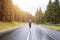 Young athletic woman jogging on hillside road