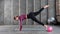 A young athletic woman practices yoga, does Pilates. A woman in sportswear stands on her hands