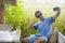 Young attractive 30s Caucasian man smiling happy and relaxed sitting at rice field coffee shop in Asia trip taking selfie picture