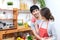 Young attractive asian couple man and woman looking at each other in kitchen. Young married asian lifestyle at home or apartment