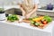 Young attractive asian woman cooks in a kitchen, chicken