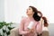 Young attractive asian woman dries her hair