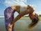 Young attractive and athletic skinny woman doing yoga stomach breathing exercise concentrated and focused at beautiful beach in