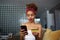 Young attractive black african female holding hands credit card and mobile phone hands. Technology, internet banking, e