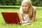 A young and attractive blond working on a laptop