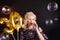Young attractive blonde woman celebrates her 30th birthday. Beautiful cheerful blonde with Golden balloons. Birthday