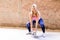 Young attractive blonde woman using a Kettlebell for crossfit weightlifting. Sporty female holding heavy weight for