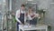 Young attractive boy and girl florists successful small business owners work in flower shop and create modern bouquet of