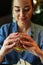 Young attractive brunette woman holding juicy burger.