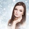 Young attractive brunette woman in a snow.