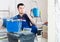 Young attractive builder handyman choosing tool in toolbox