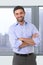 Young attractive business man standing in corporate portrait