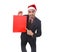 Young attractive businessman in Christmas Santa hat holding and pointing red shopping bag in December and New year sale