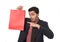 Young attractive businessman holding and pointing red shopping bag in sale concept performing as salesman