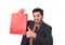 Young attractive businessman holding red shopping bag in sale concept performing as salesman