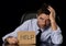 Young attractive businessman in worried tired and stressed face expression sitting depressed on office chair