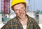 Young attractive and confident contractor or construction worker man with builder safety helmet posing corporate smiling cheerful