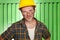 Young attractive and confident contractor or construction worker man with builder safety helmet posing corporate smiling cheerful