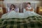 Young attractive couple in bed with social media addict woman using internet mobile phone ignoring frustrated and upset man moody