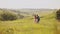 Young attractive couple dance and hug in a wide open yellow field on a sunny day close-up