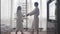Young attractive couple dancing in bathrobe after arriving to hotel.