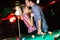 Young attractive couple on date in snooker club