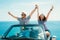 Young attractive couple posing in a convertible car