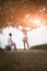 Young attractive couple sitting flirting together on dirt road