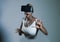 Young attractive curious black afro american woman wearing VR 3d vision goggles enjoying amazing experience playing and having fun