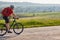 Young attractive cyclist riding mountain bike on the country road.