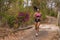 Young attractive and exotic Asian Indonesian runner woman in jogging workout outdoors at countryside road track nature running