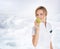 A young attractive female doctor eating an apple