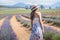 Young attractive female with a white dress is posing for the camera in the Lavanda field