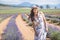 Young attractive female with a white dress is posing for the camera in the Lavanda field