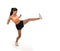 Young attractive and furious latin sport woman in fight and kick boxing training workout throwing aggressive kick attack