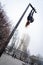 Young attractive Girl hanging by feet upside down on the street light in the street. super extreem. concept of courage