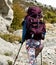 Young attractive girl hiking on rocky mountin.