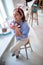 A young attractive girl in a pastry shop brighten up her day with delicious donuts. Pastry shop, dessert, sweet