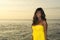 Young attractive and glamorous African American black woman in chic and elegant summer dress posing relaxed on summer sunset