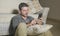 Young attractive and handsome man sitting at living room floor focused and concentrated using mobile phone networking or dating