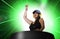 Young attractive and happy Asian Korean DJ woman remixing using deejay gear and headphones at night club with lights background in